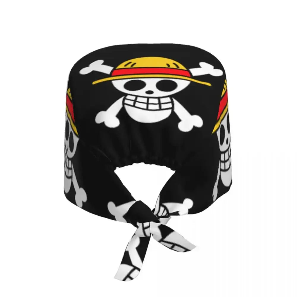 Black fabric one piece scrub cap featuring white skulls and crossbones with yellow hats as fan accessory