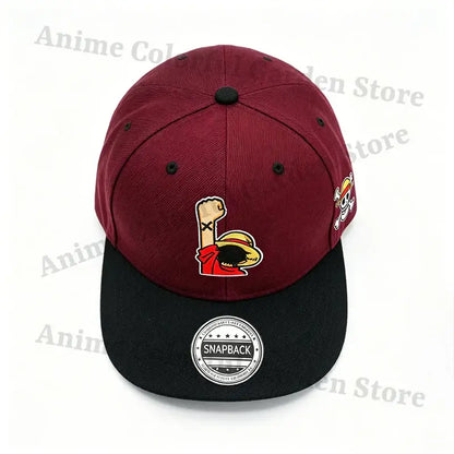Maroon and black cotton baseball cap with embroidered luffy fist logo front and skull emblem side one piece straw hat design