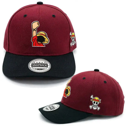 Maroon and black cotton baseball cap featuring embroidered one piece character luffy with raised fist and skull patch