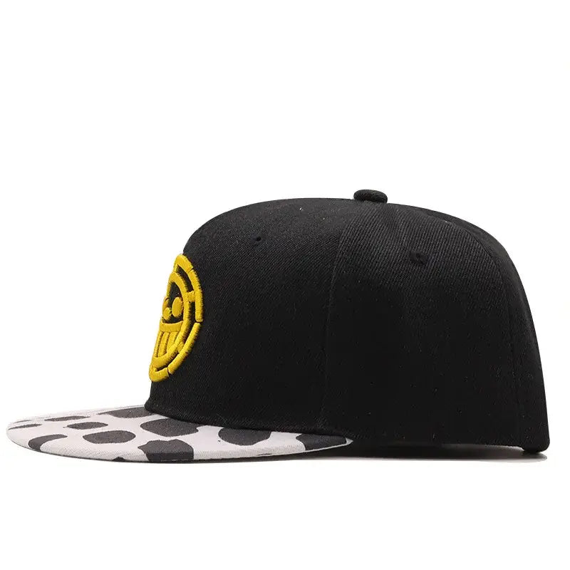 One Piece Tony Tony Chopper black snapback cap with yellow skull logo and white brim with black cow print pattern