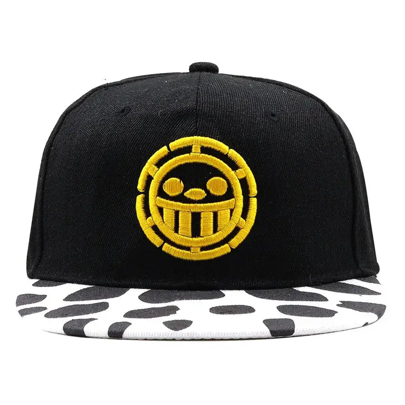 Black snapback cap with bold yellow skull logo and white brim with black cow print one piece tony tony chopper baseball cap