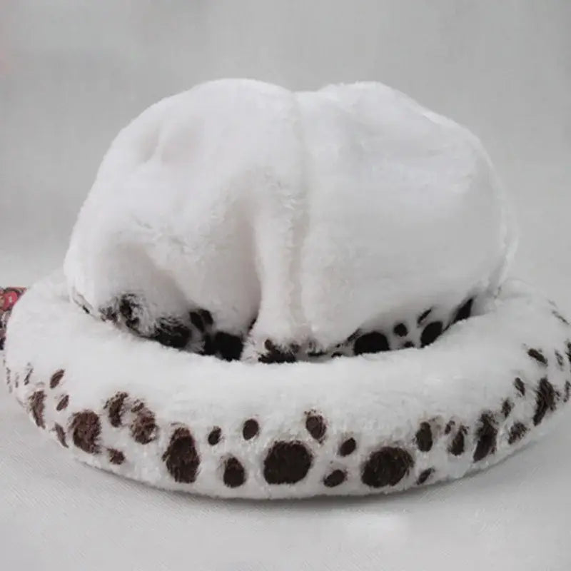 White plush cat-shaped pet bed with brown paw prints shown alongside trafalgar law cosplay hat accessory