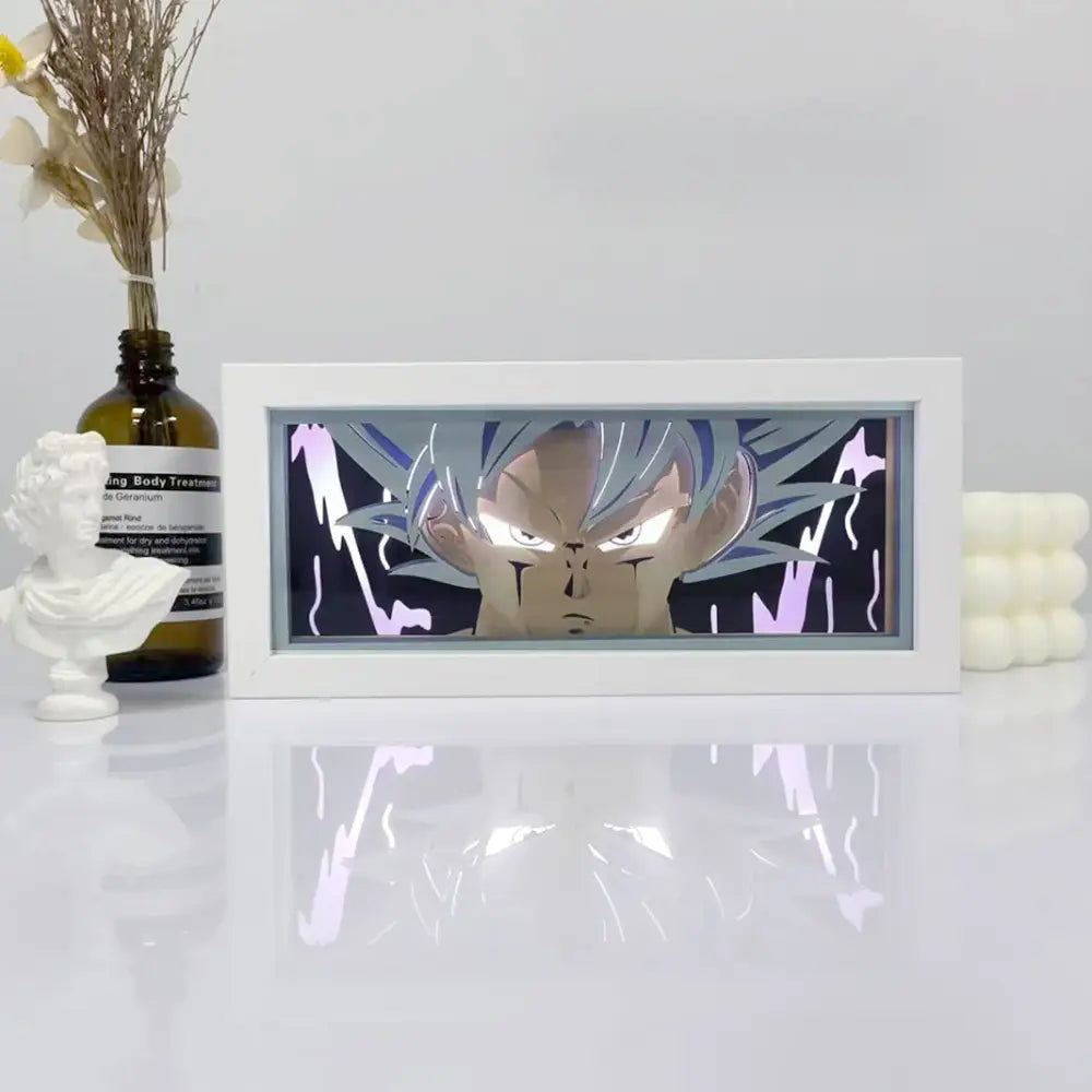 White-framed shadow box light featuring a detailed illuminated goku face with silver hair and purple energy effects