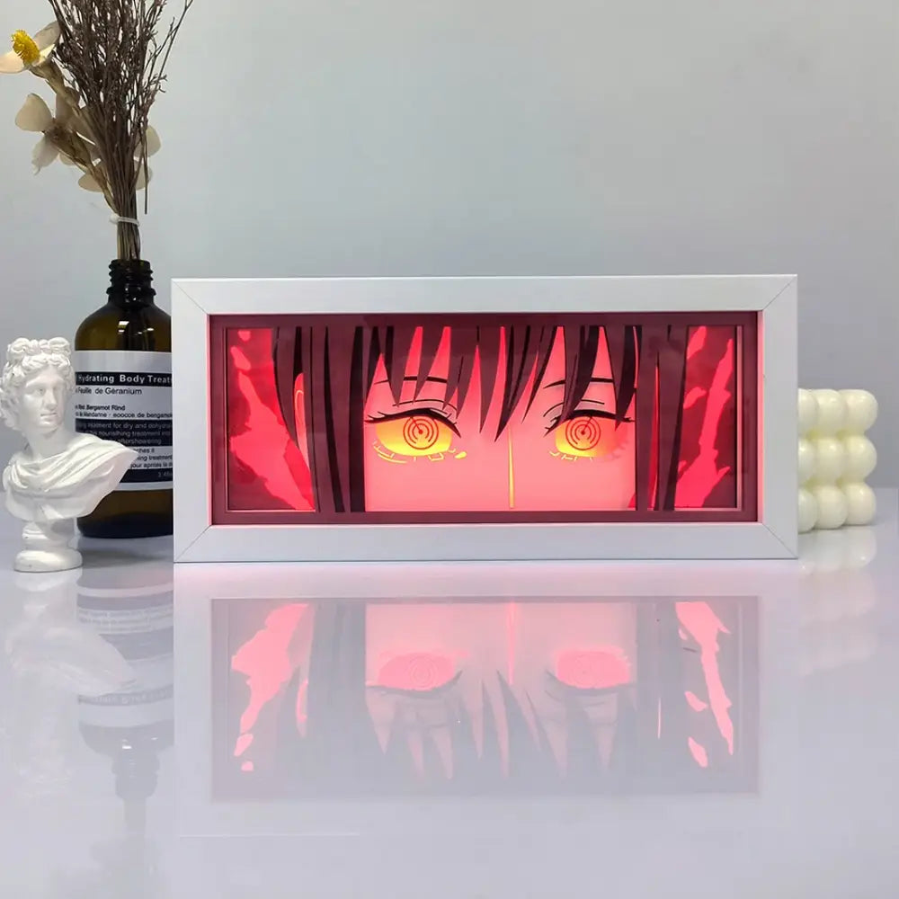 White-framed one piece zoro paper cut shadow box light with glowing orange anime eyes and red backlight box light
