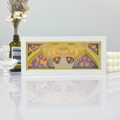 White-framed layered paper art of sailor moon with golden hair and orange eyes in a purple background shadow box light