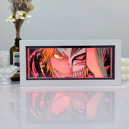 White framed one piece zoro paper cut shadow box light featuring glowing red and orange character with sharp teeth