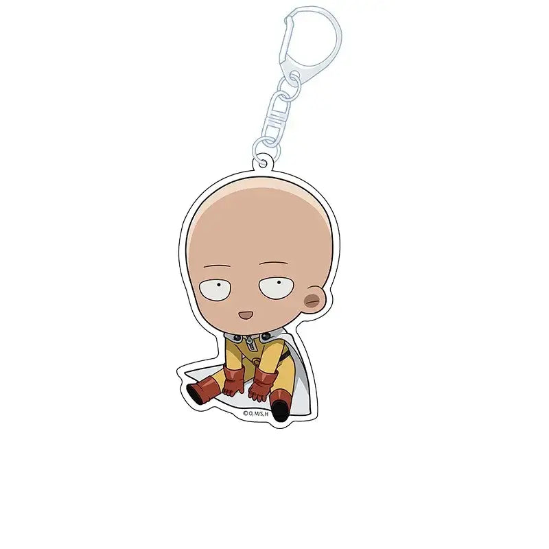 One punch man king acrylic keychain featuring a cute chibi charm of saitama in yellow and red gear seated pose