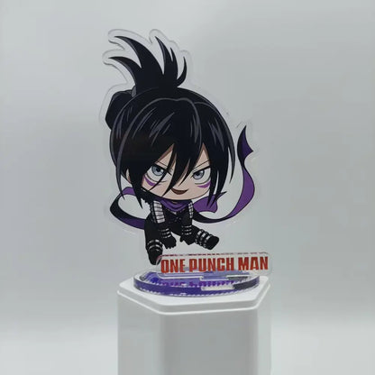 Chibi-style saitama acrylic stand with black hair and purple scarf on transparent base featuring one punch man branding