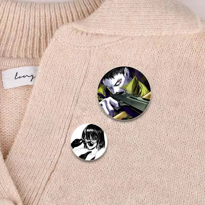 Two circular punch man saitama button pins featuring a yellow character and a black and white girl with sunglasses design