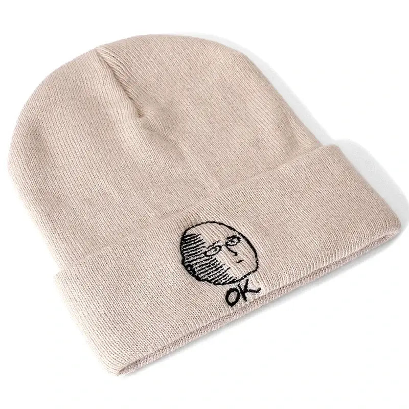 Beige cotton knit one punch man saitama beanie with black embroidered face and ok text on the cuff