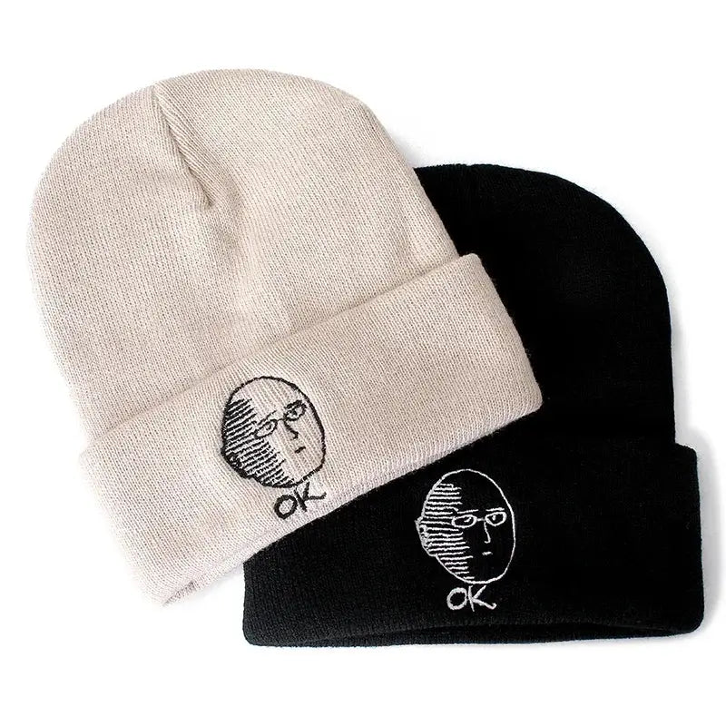 Beige and black cotton knit beanies featuring embroidered punch man saitama faces with ok text beneath each
