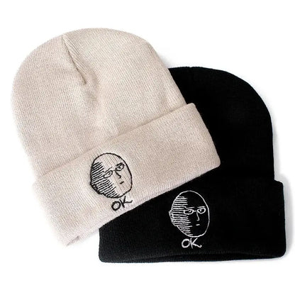 Beige and black cotton knit beanies featuring embroidered punch man saitama faces with ok text beneath each