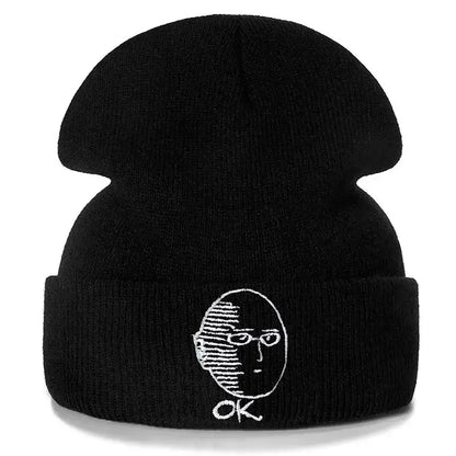 Black cotton knit beanie featuring white embroidered punch man saitama face with glasses and ok letters below