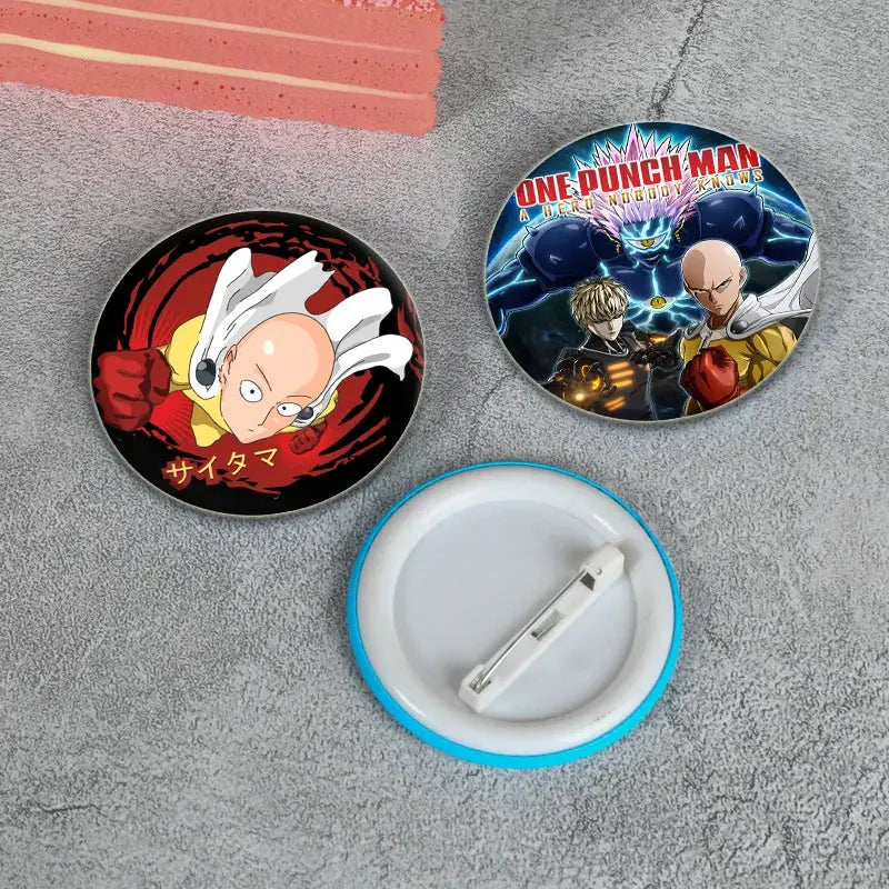 Two circular one punch man enamel badge lapel pins featuring saitama in red and black and multiple characters on blue background