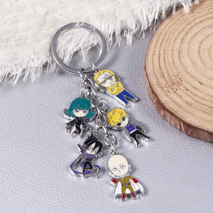 A silver-toned man saitama metal keychain with five colorful enamel one punch man saitama character charms
