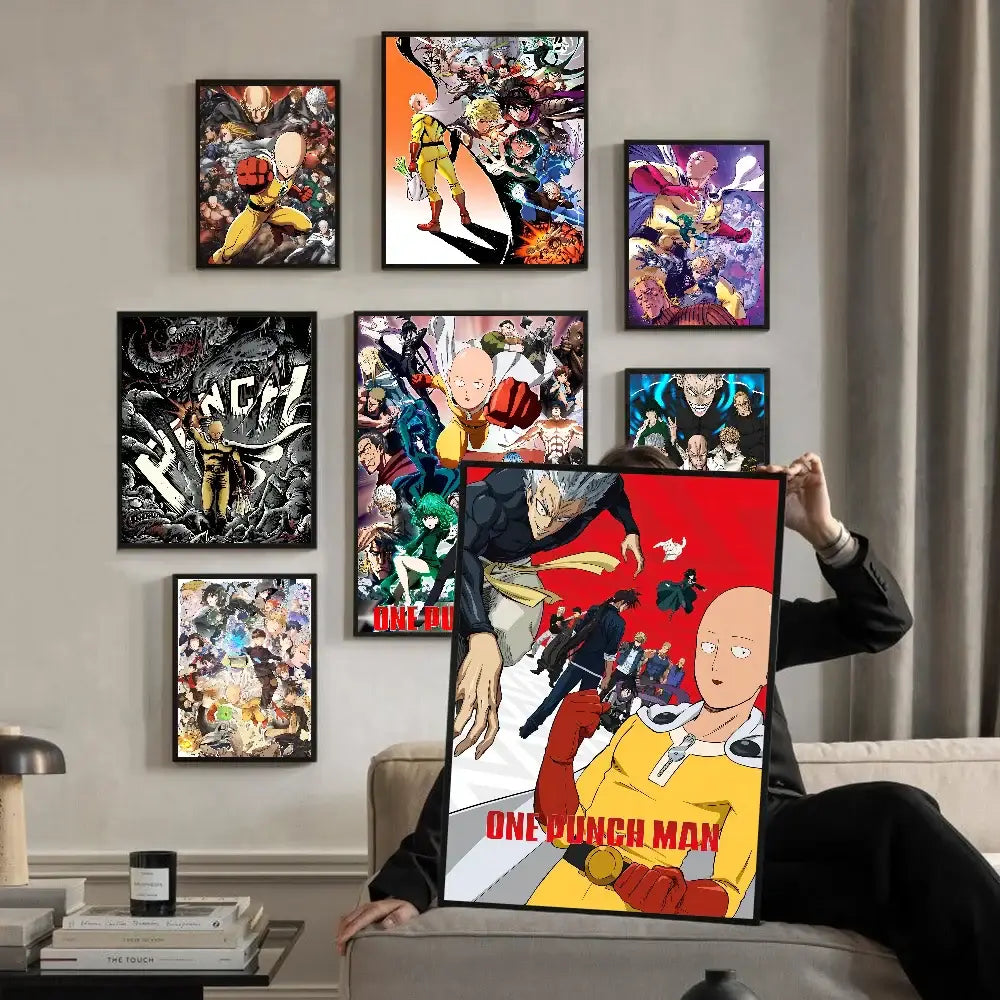Person holding a 'One Punch Man' poster in a room with framed posters on the wall.