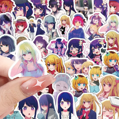 A hand holds a colorful hoshino sticker with pastel green hair and pink eyes from 50pcs aesthetic diy scrapbook kit