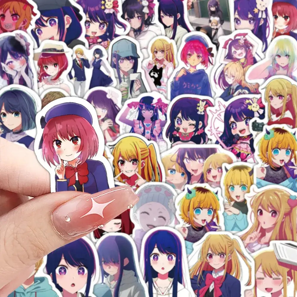 A hand holds a vibrant pink-haired hoshino sticker from the 50pcs aesthetic diy scrapbook set featuring anime art