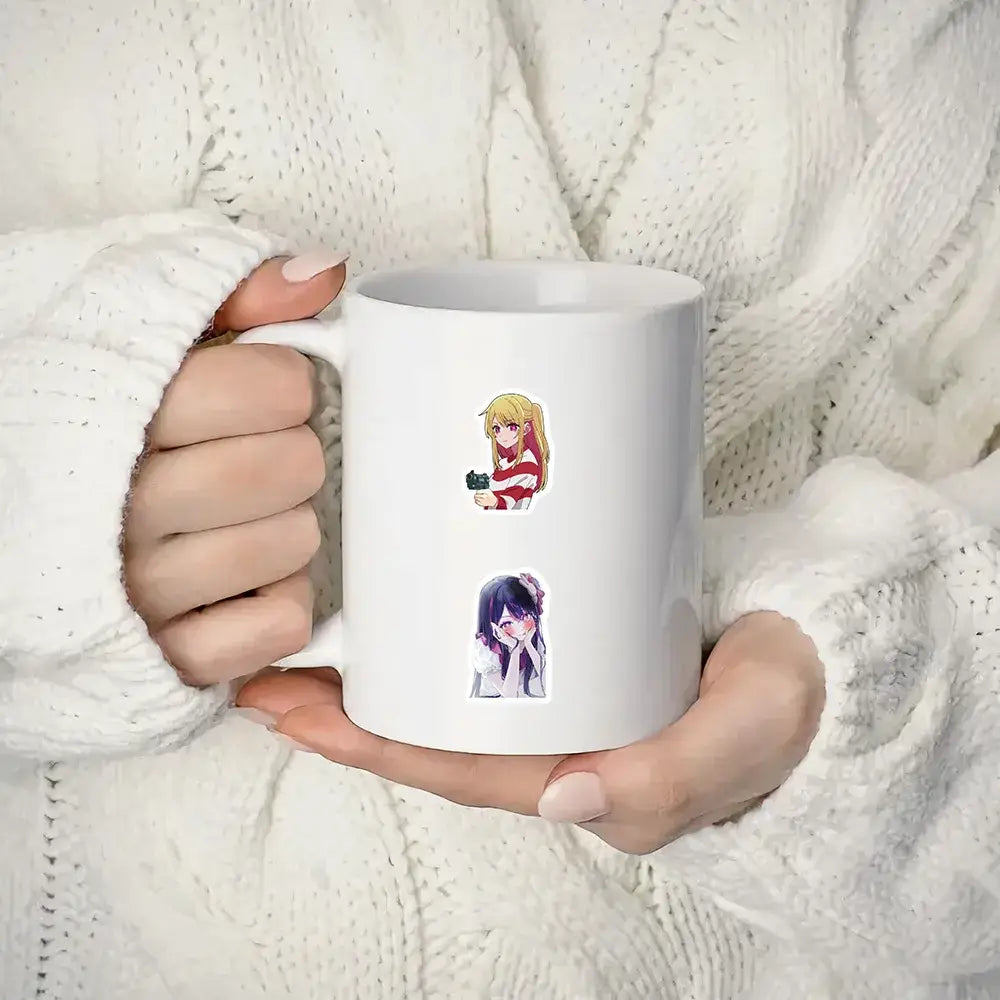 White ceramic mug with two oshi no ko ai hoshino stickers from 50pcs aesthetic diy scrapbook set
