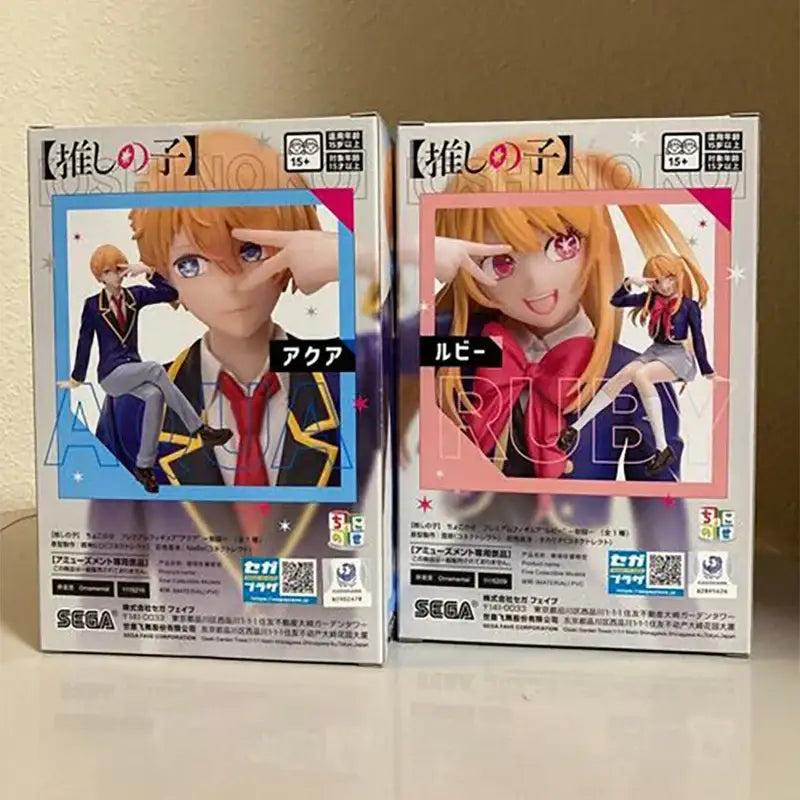 Two oshi no ko pvc figures of akura and ruby in branded packaging featuring vibrant artwork and ruby pvc figures