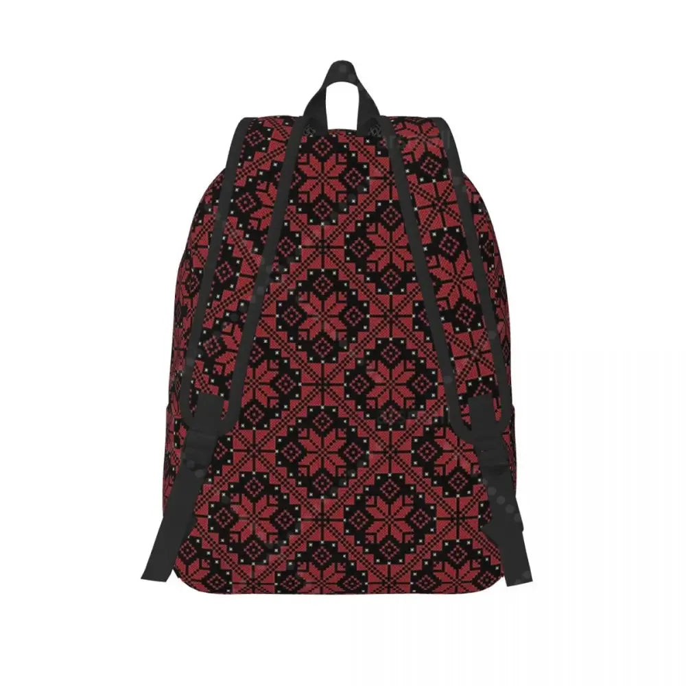 Palestinian tatreez embroidered canvas laptop backpack with bold red and black geometric snowflake pattern and white dots