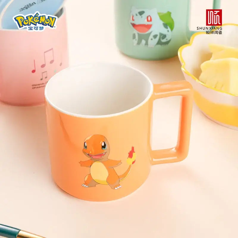 Orange ceramic mug featuring a cartoon charmander design for coffee and tea use in the pokemon collection