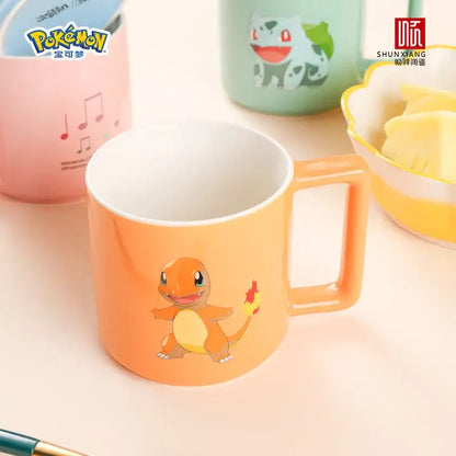 Orange ceramic mug featuring a cartoon charmander design for coffee and tea use in the pokemon collection