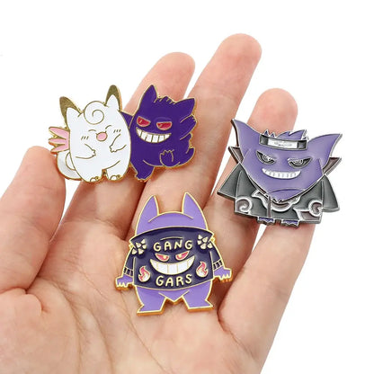 A hand holds four colorful pokemon gengar enamel lapel pins with unique outfits perfect as backpack badges