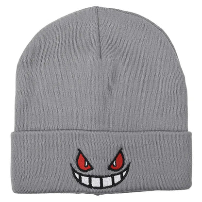 Gray knit winter hat featuring embroidered red eyes and a wide white-toothed grin inspired by pokemon gengar