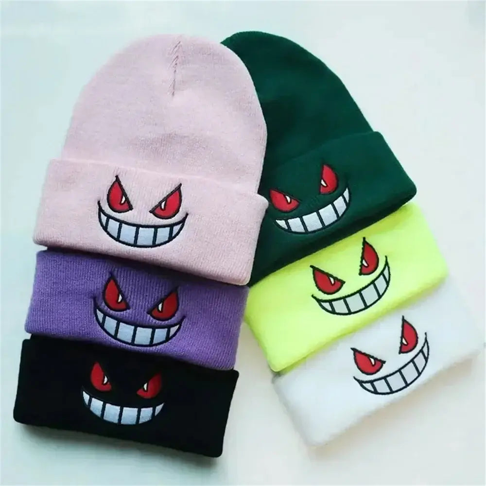 A collection of five colorful pokemon gengar knit beanies with embroidered cartoon faces and red eyes winter hats