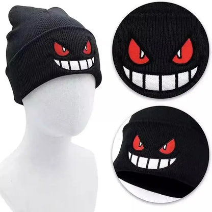 Black knitted beanie featuring bold embroidered gengar face with red eyes and white teeth winter hat for warmth