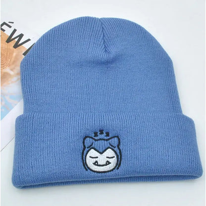 Light blue knitted hood hat featuring an embroidered sleepy snorlax face in plush knit style