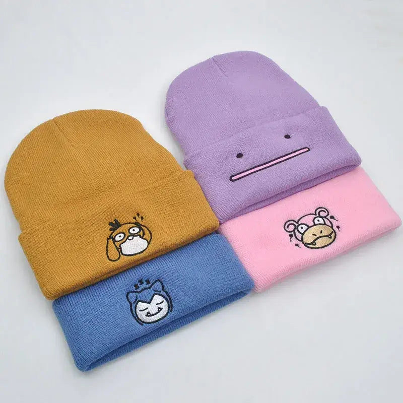 Four colorful pastel knitted hood hats with embroidered Pokémon faces in plush knit style for cozy wear