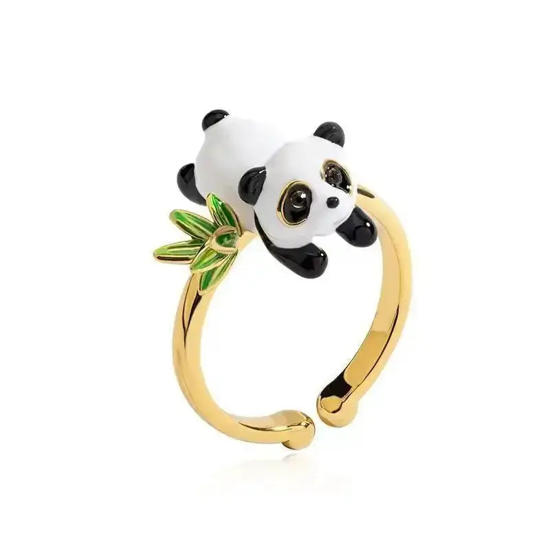 Gold-toned 925 silver couple ring featuring a glossy white and black panda clutching green bamboo leaves