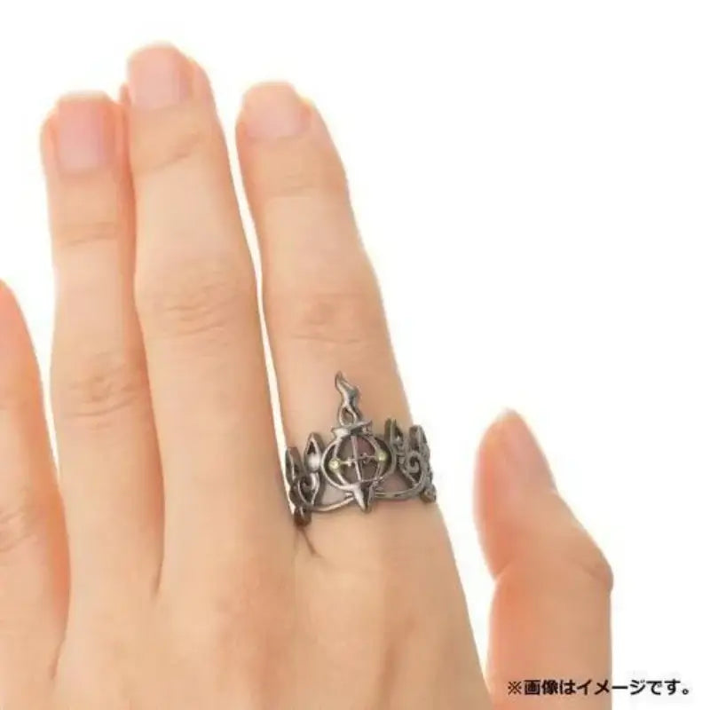 Silver-toned 925 silver pokemon litwick dragonair couple ring with intricate ornate design and central crown emblem