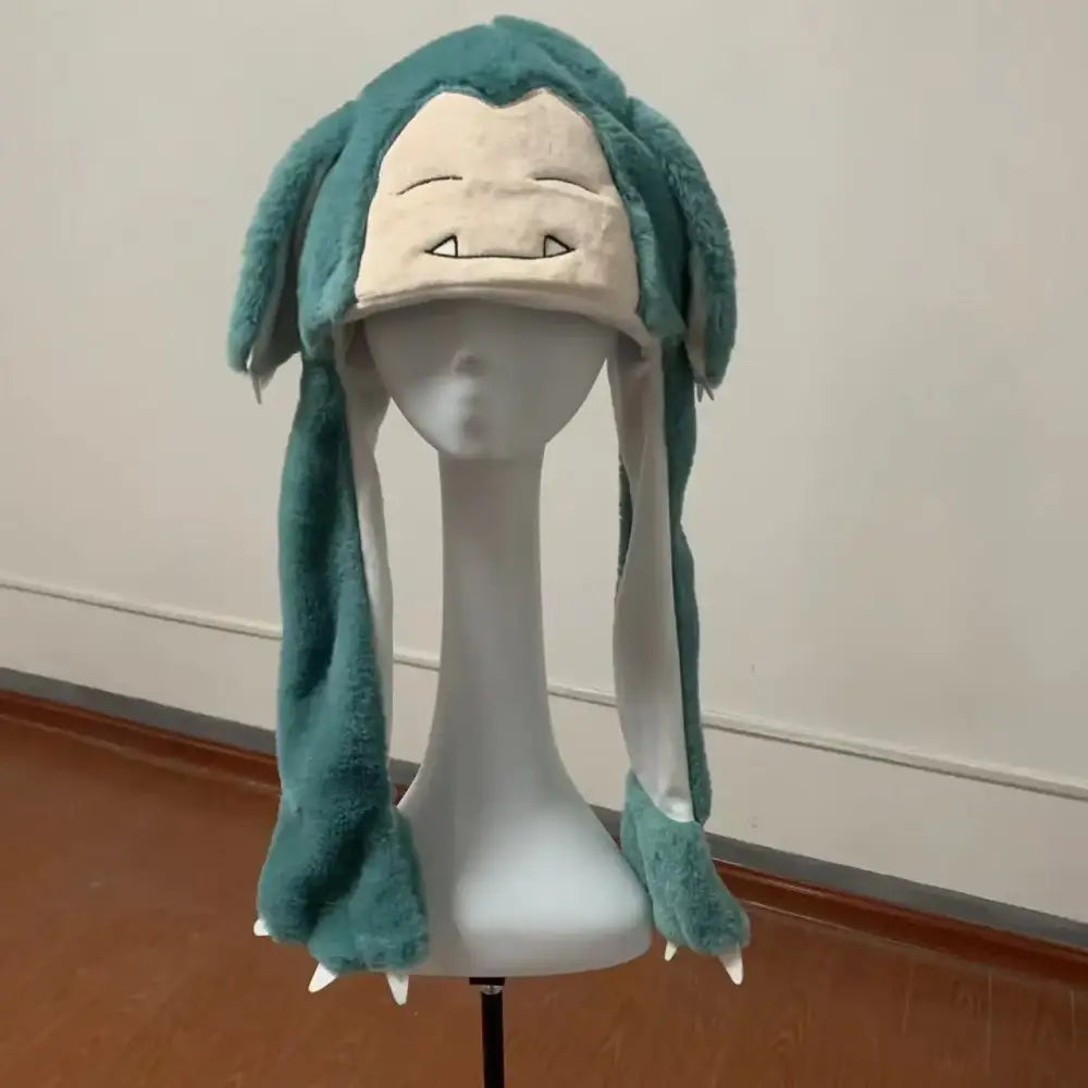 A plush teal and cream snorlax airbag hat with pinch ears, long floppy ears, clawed feet, perfect for winter warm use