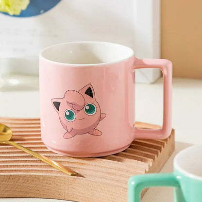 Pink ceramic mug featuring a jigglypuff illustration with green eyes and black ears in a pikachu ceramic mug design