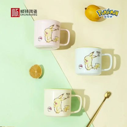 Three pikachu ceramic mugs in pastel pink light blue and cream with kawaii pattern yellow illustrations