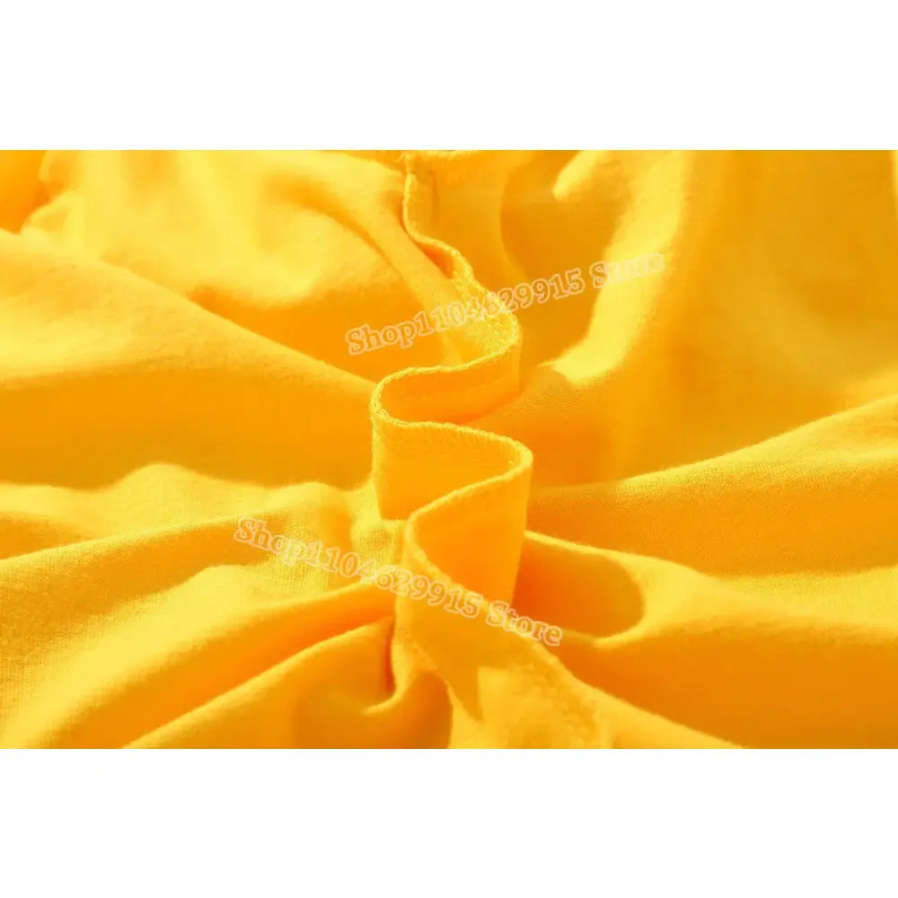 A vibrant yellow soft cotton Pokemon Pikachu and Eevee t-shirt fabric with gentle ruching and natural folds