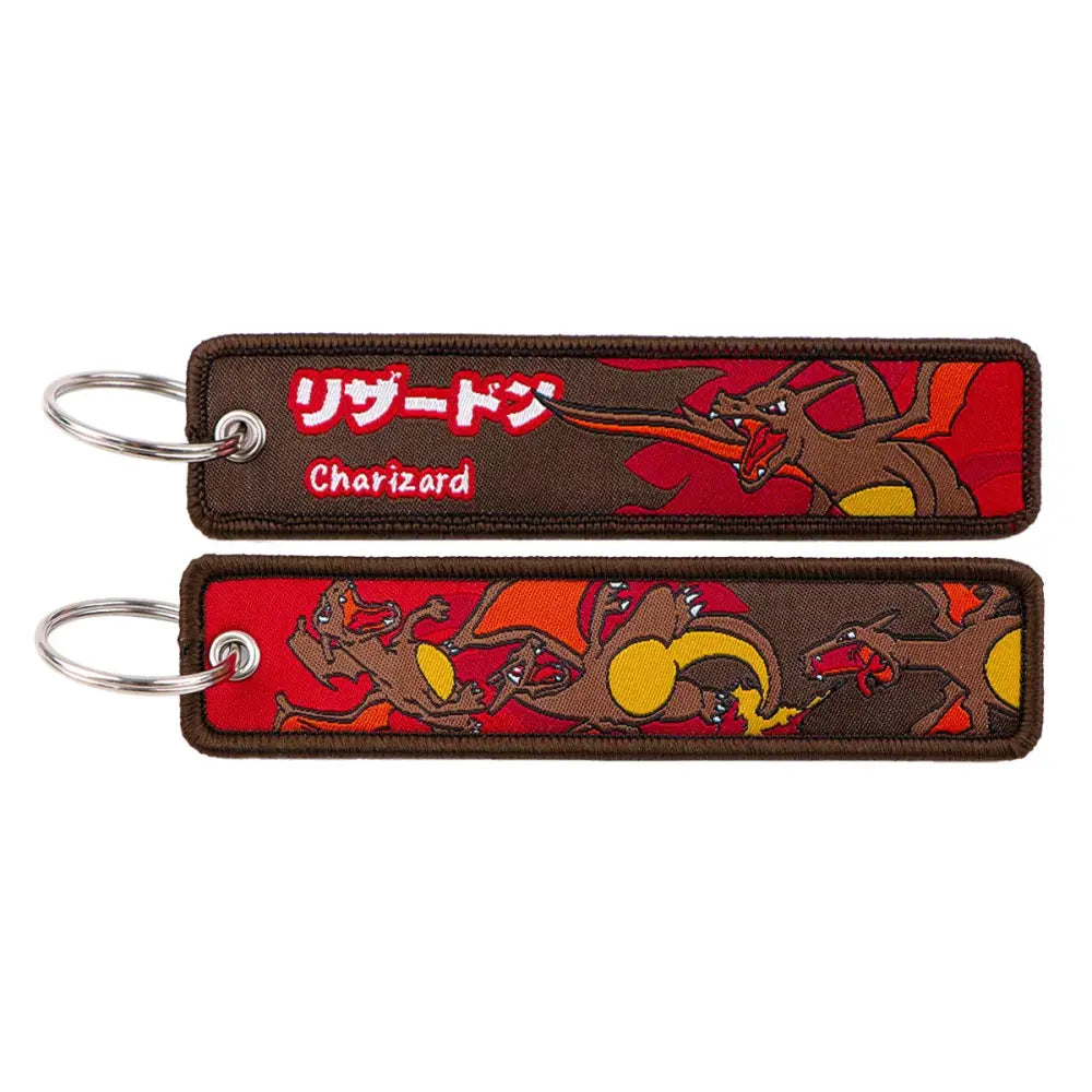 Brown embroidered pokemon pikachu keychain featuring red and orange charizard design with japanese text and jet tag accessory