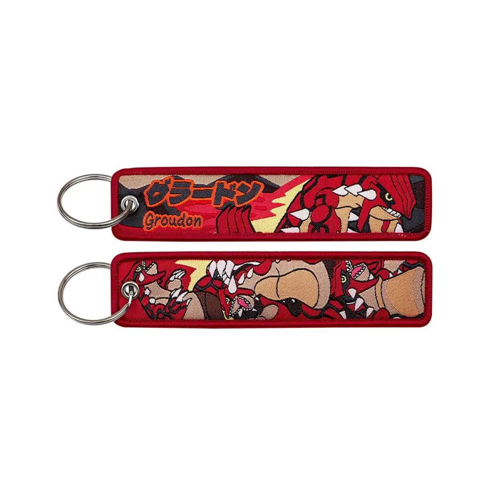 Red embroidered pokemon keychain featuring groudon with japanese text and detailed artwork for jet tag accessory
