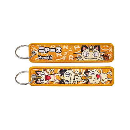 Orange embroidered pokemon keychain featuring meowth stitched design and japanese text for jet tag accessory use
