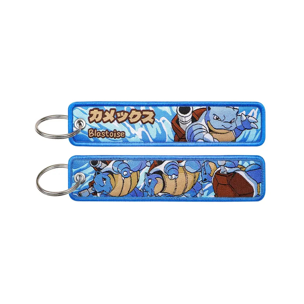 Blue embroidered pokemon blastoise keychain with japanese text and dynamic water design for jet tag accessory