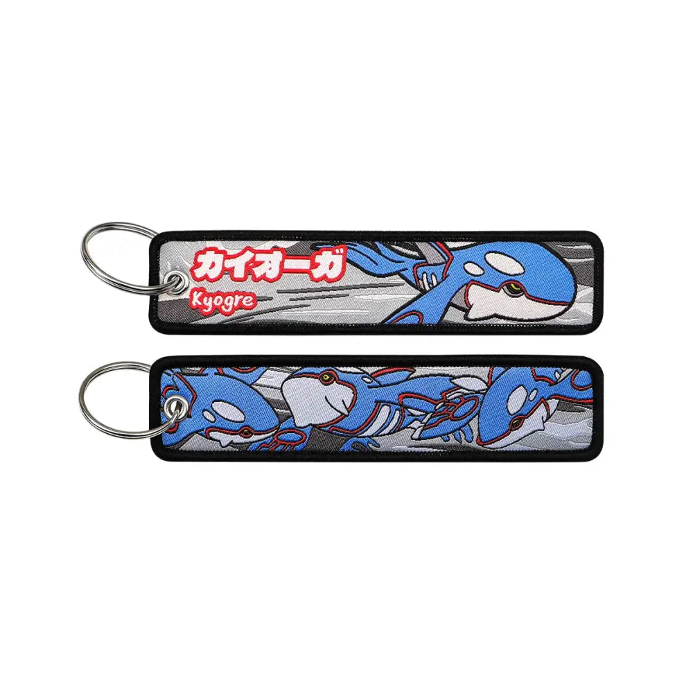 Blue and white embroidered Kyogre keychain with black trim from the Pokemon Pikachu embroidered jet tag accessory