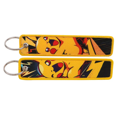 Yellow pikachu embroidered keychain with black and red comic-style design and embroidered edges for jet tag accessory
