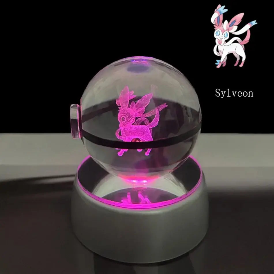 Pokemon pokeball led night light featuring a glowing pink sylveon hologram inside a crystal ball-shaped lamp with white base