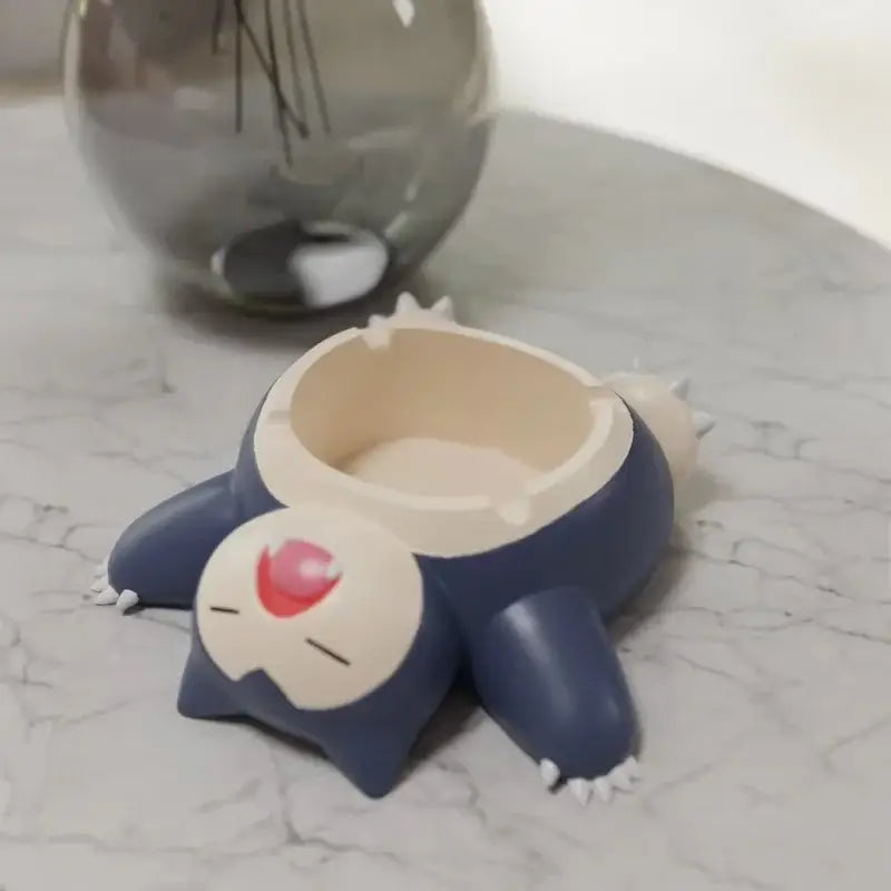Pokemon Snorlax ashtray ornament in blue and cream with white claws and red cheek mark for desktop decor