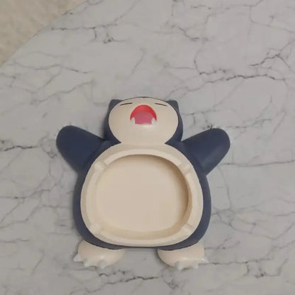Pokemon snorlax ashtray ornament in dark blue and cream with a red mouth designed as a playful desktop decor accessory
