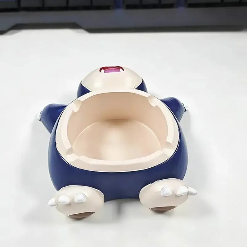 Blue and white snorlax-shaped ashtray with glossy plastic finish for desktop decor and smoking accessory use