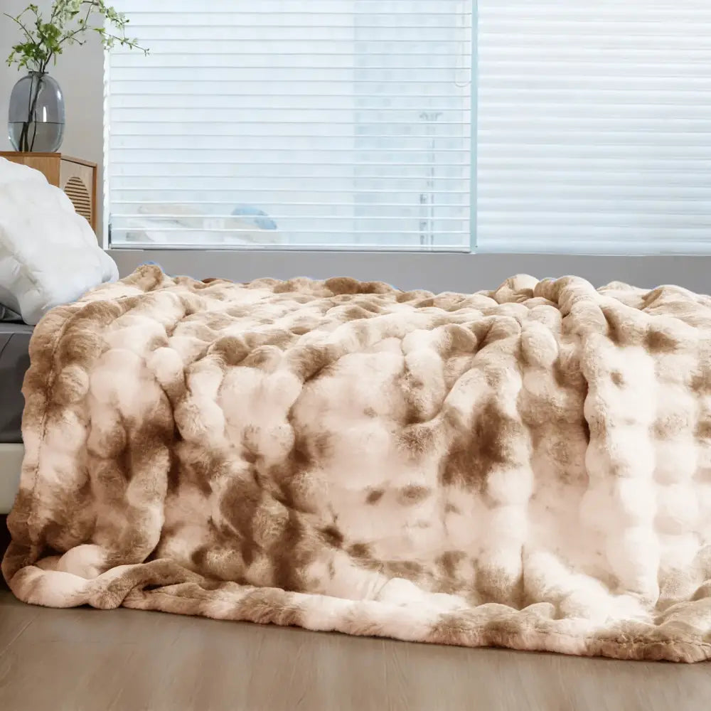 Cream and tan faux rabbit fur throw blanket with plush textured surface soft cozy warm thick faux fur material